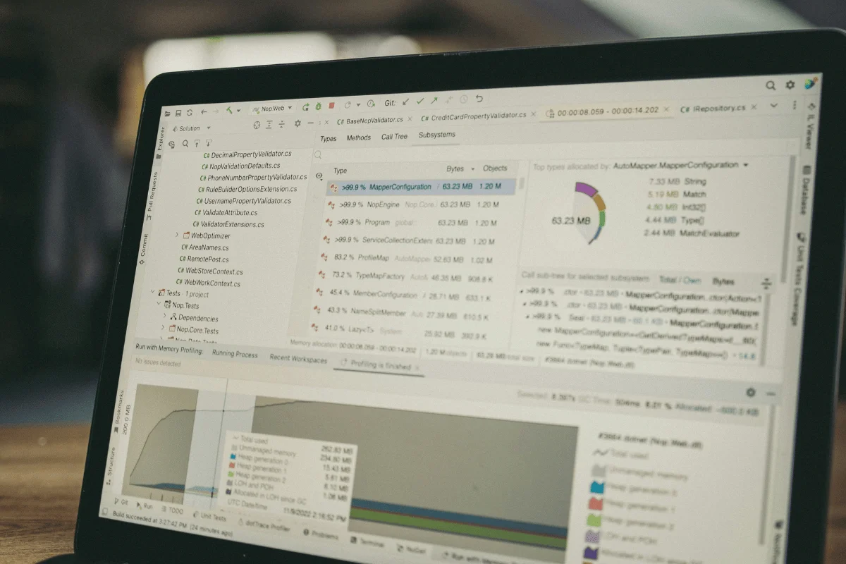 A laptop screen displaying software profiling results, including memory usage and project files in a development environment.